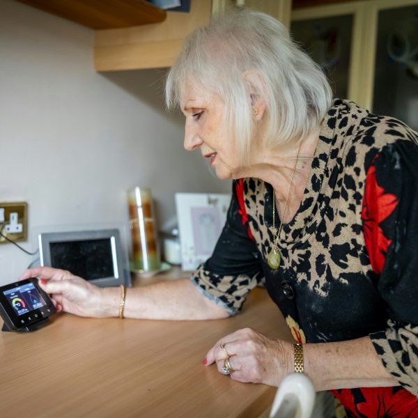 Photo of woman viewing smart meter.