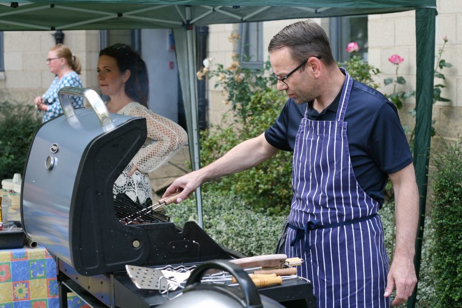 Photo of Martin cooking food on the BBQ.