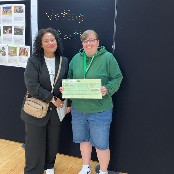Photo of Leigh handing over the cheque.