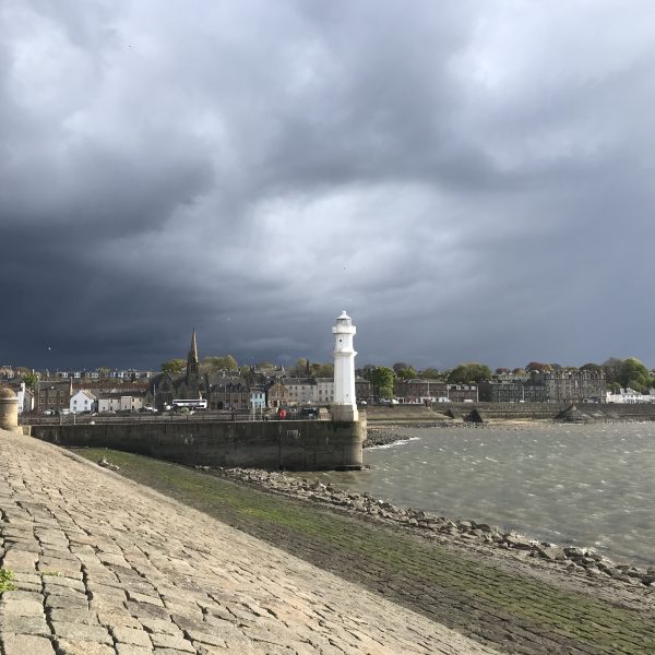 Photo of Newhaven harbour surrounded by dark clouds.