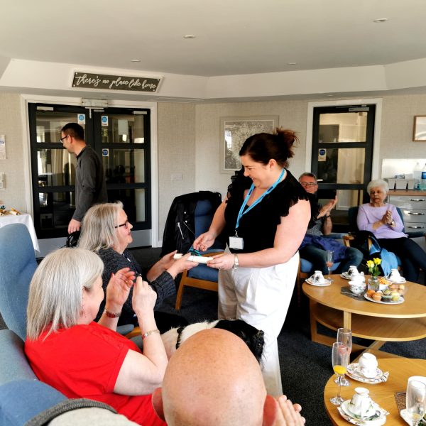 Photo of certificates being handed out to sheltered housing tenants.