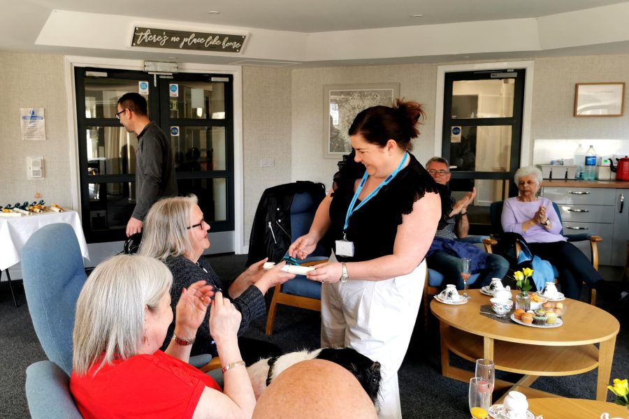 Photo of certificates being handed out to sheltered housing tenants.