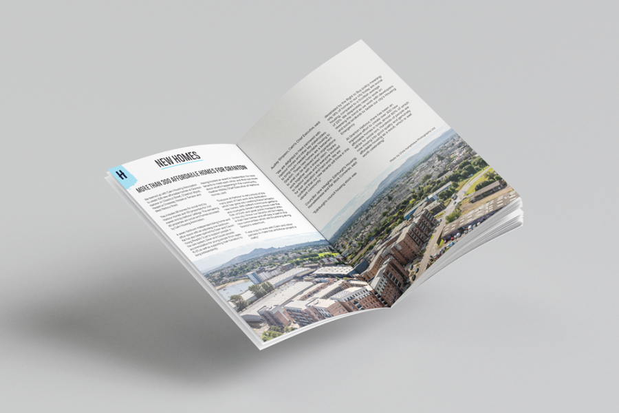 Photo of the Annual Report opened to a page titled 'New Homes'.