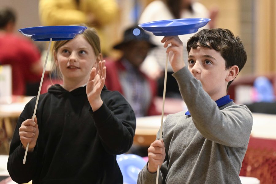 Photo of two children spinning plates.