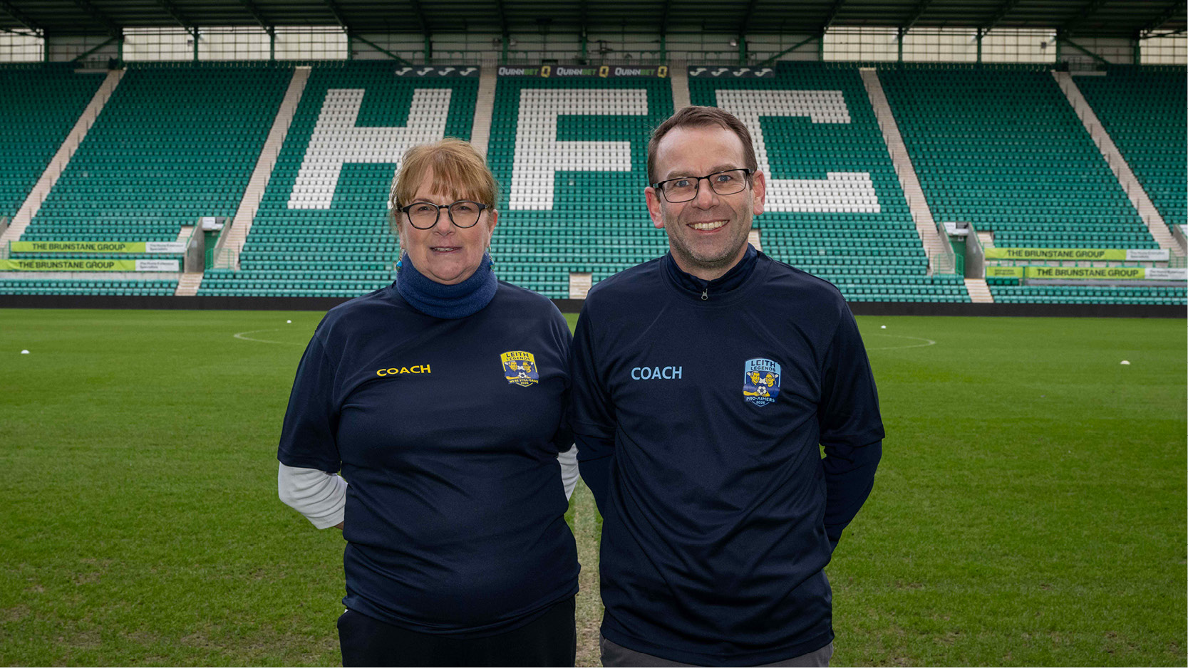 Photo of Maureen Combe and Martin Hunter wearing their coach t-shirts.