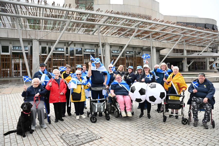 Photo of the Leith Legends outside the Scottish Parliament Building.