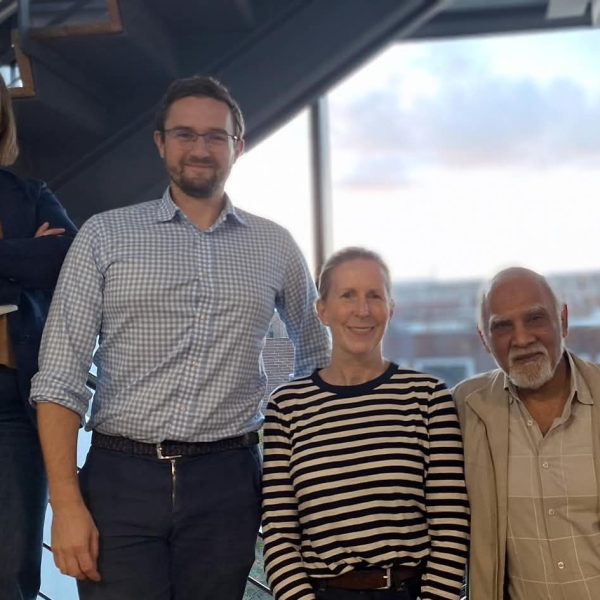 Photo of four new Board Members standing on staircase with Leith in background.