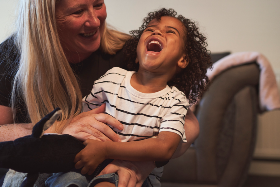 Photo of a mother and child laughing.