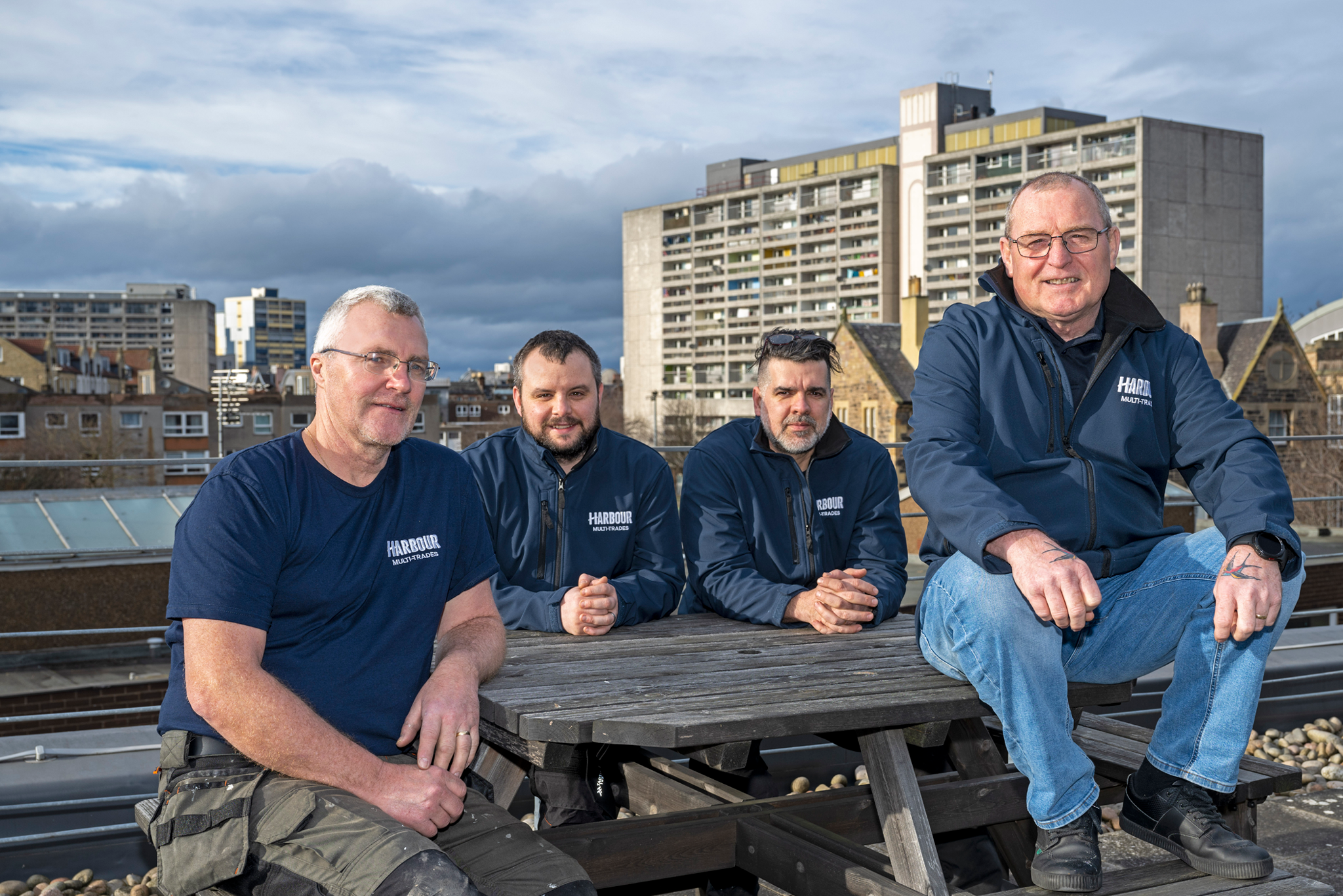 Photo of four engineers sat outside on a picnic bench.