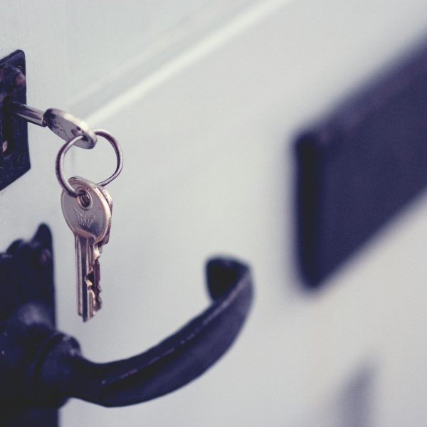 Photo of a key in a door.