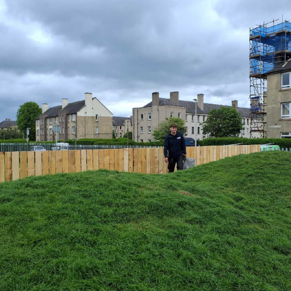 Photo of a Harbour Multi-Trades joiner standing in front of a newly installed fence.
