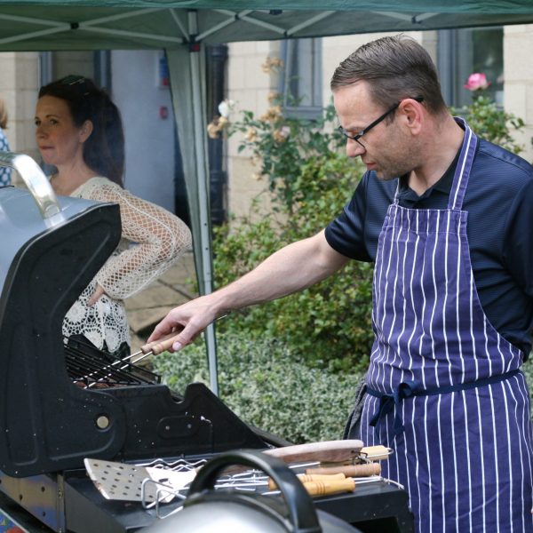 Photo of Martin cooking food on the BBQ.