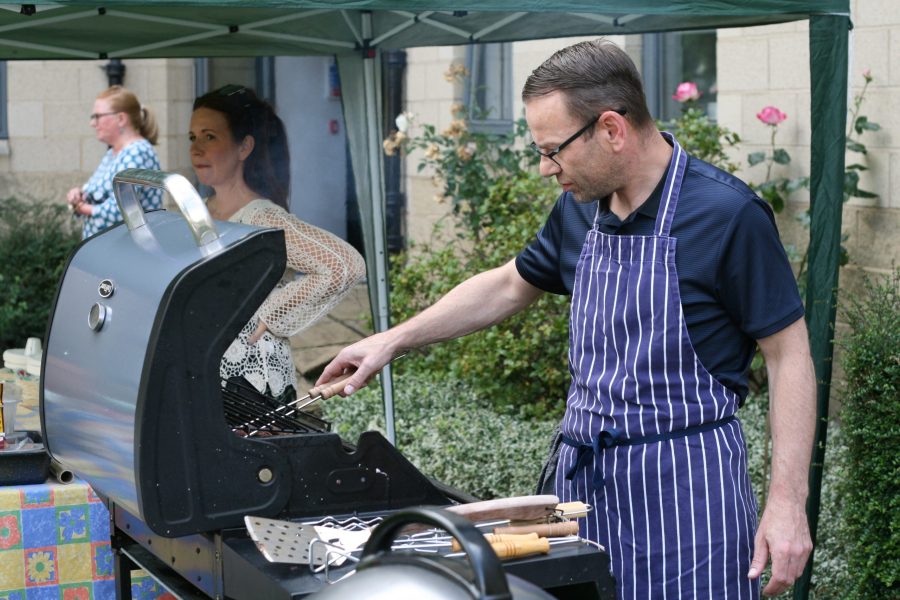 Photo of Martin cooking food on the BBQ.